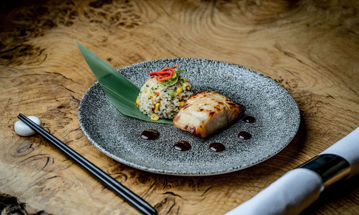 Plate of Japanese-inspired grilled fish on a wood table