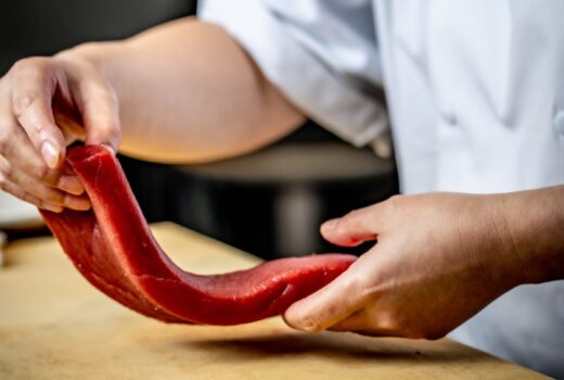 Chef handling raw fish
