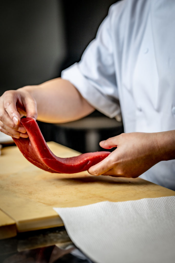 Chef handling raw fish