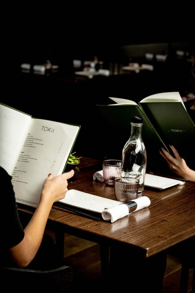 Two people looking at TOKii menu