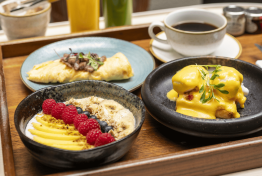 Breakfast platter with eggs, fruit, and coffee.